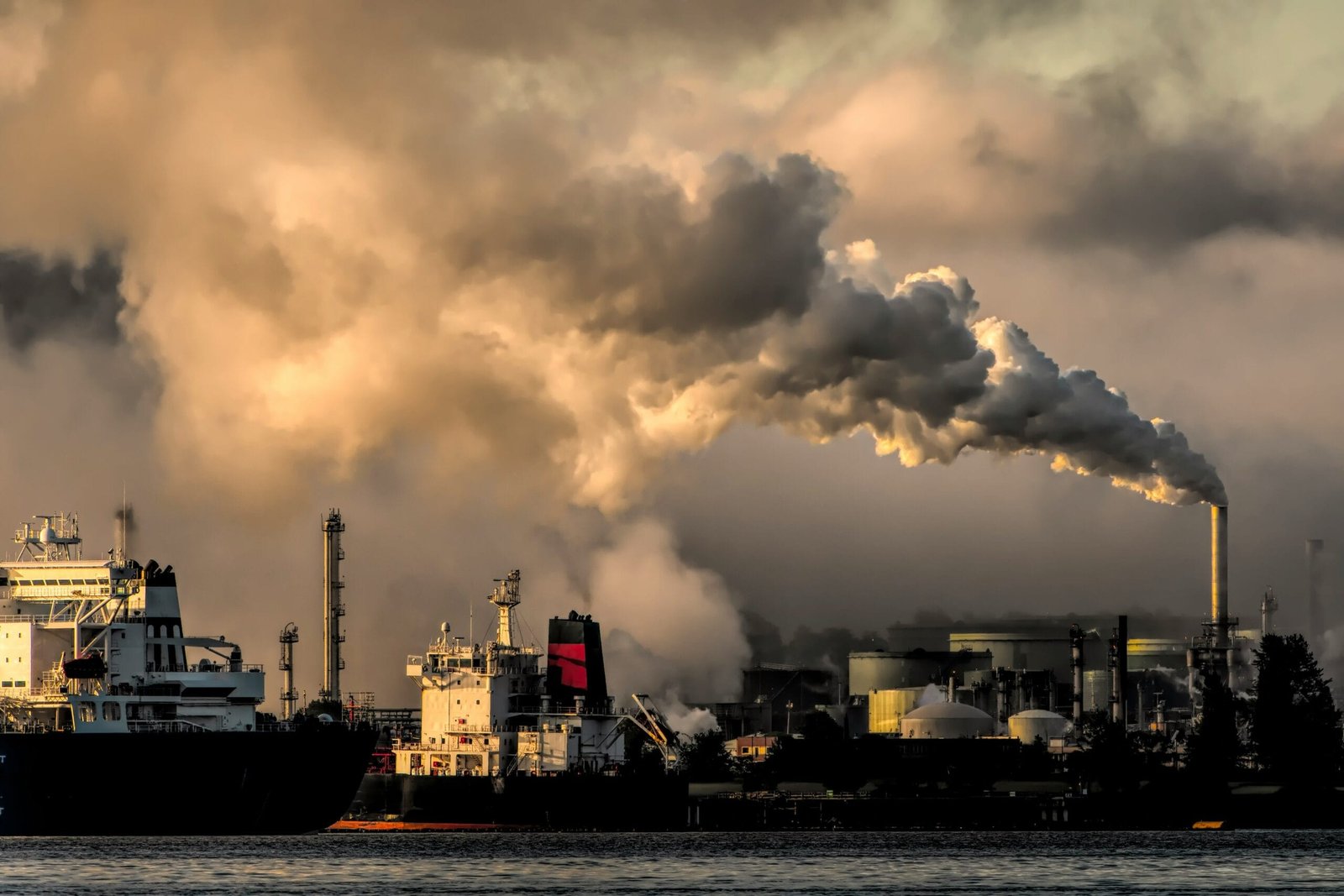 white and black ship on sea under white clouds